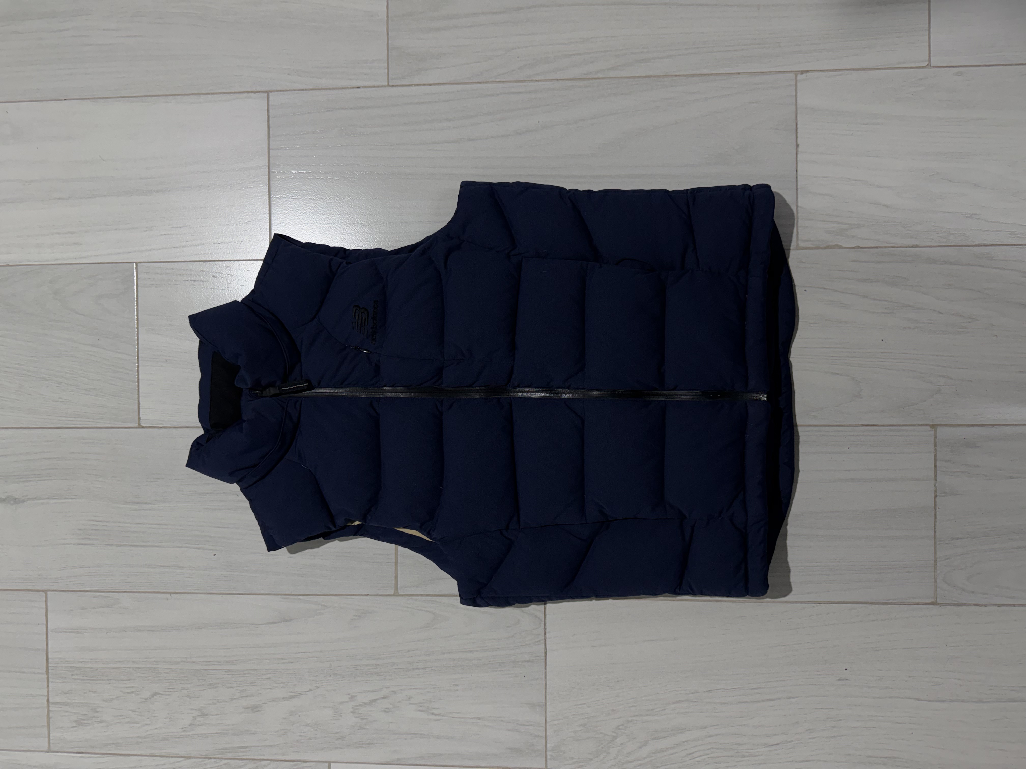 New Balance — Chaleco puffer